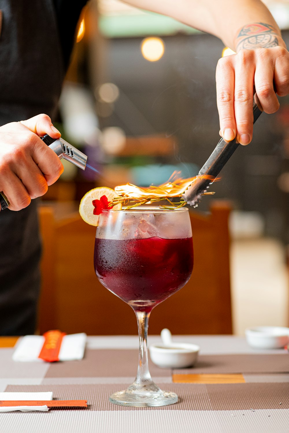 a person cutting a piece of food with a knife and fork