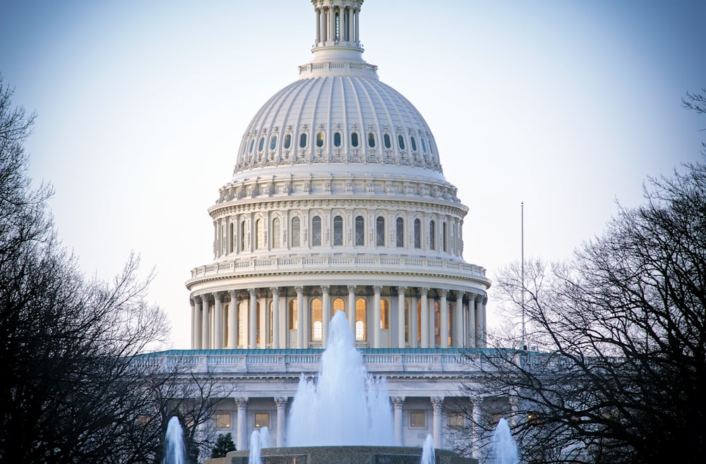 the dome of the capital building with a fountain in front of it