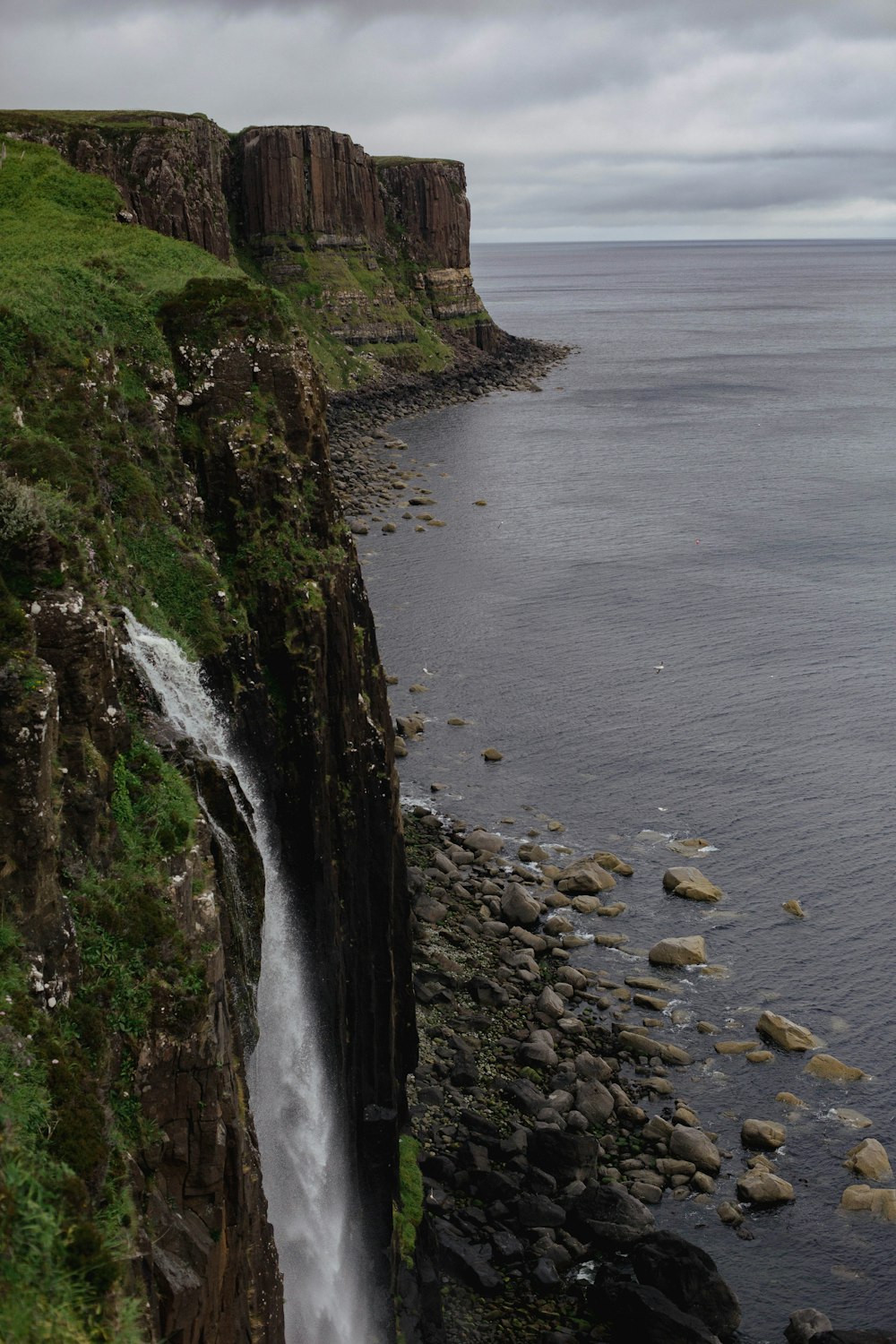 a waterfall flowing into a body of water