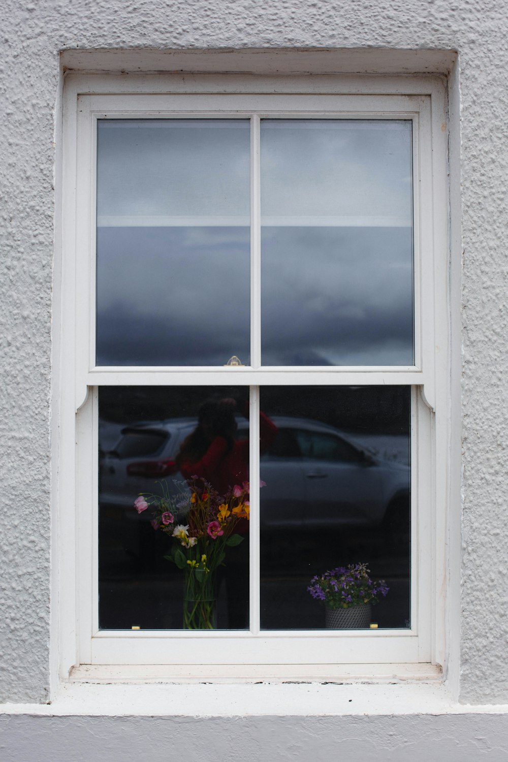 a vase of flowers sitting in front of a window