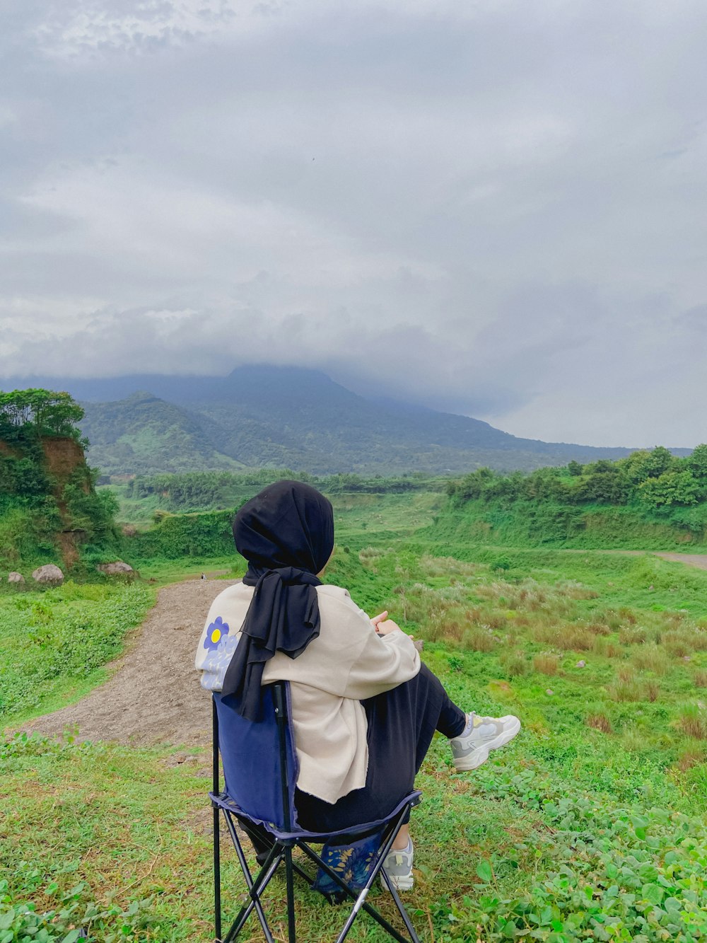 a person sitting in a chair in a field