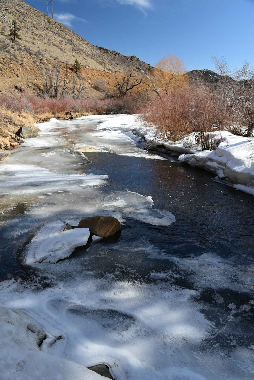 a river running through a snow covered forest