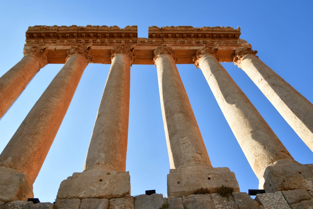 a group of tall stone pillars against a blue sky