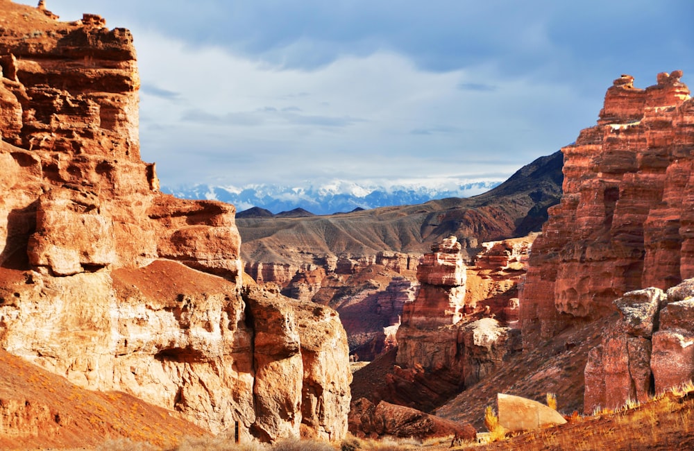 a rocky landscape with mountains in the background