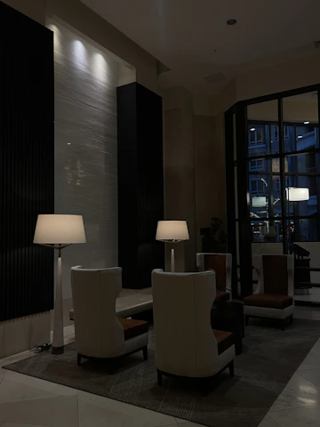 Guests networking in an intimate lounge area with dark, stylish furnishings.