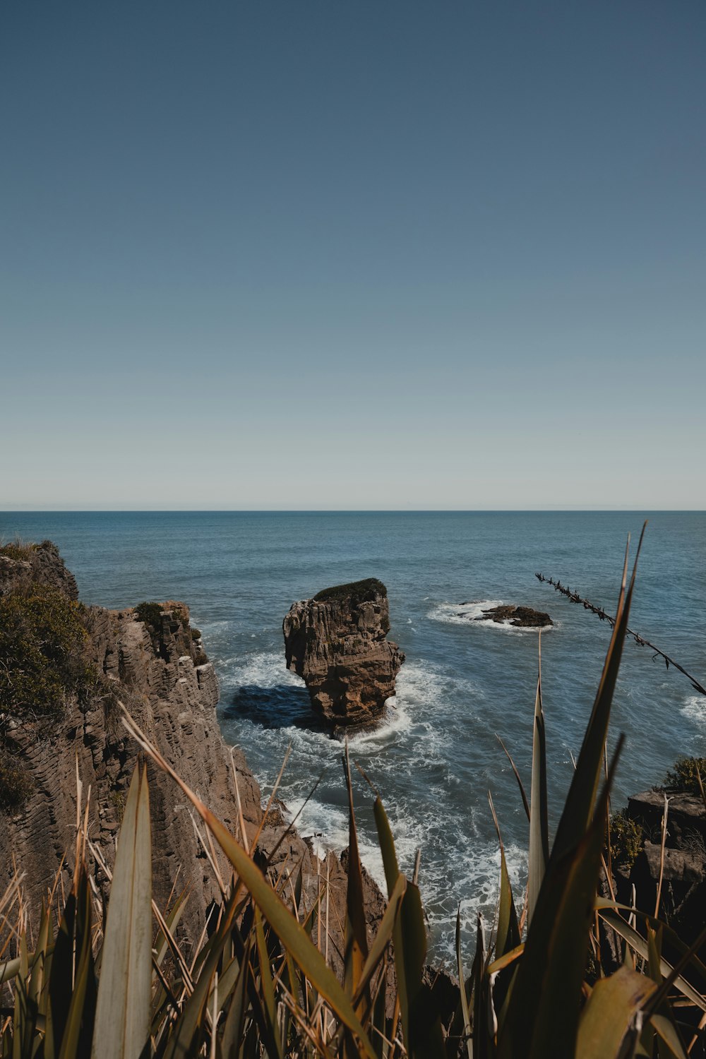 a rock outcropping in the middle of the ocean