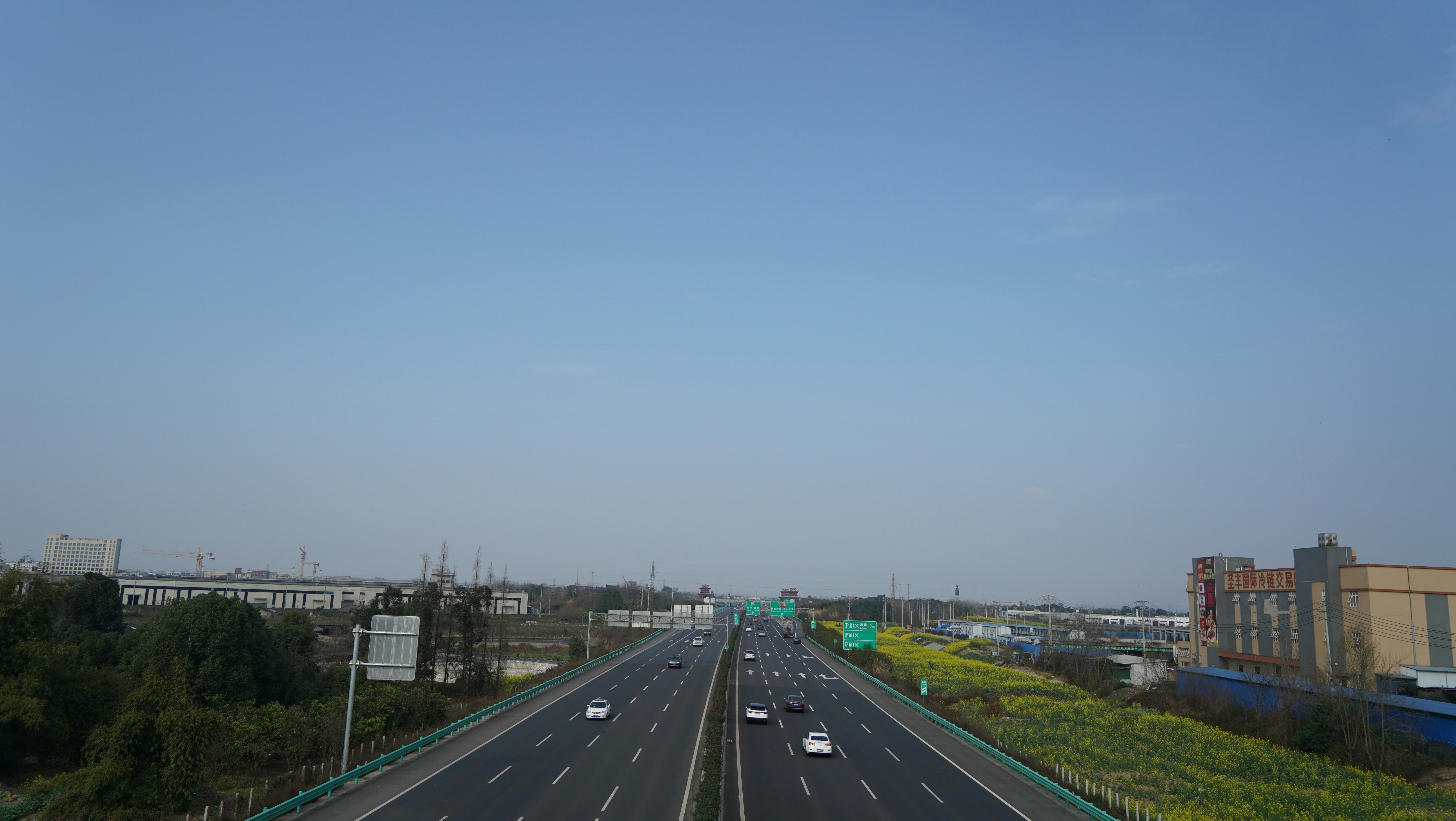 a highway with a few cars driving down it