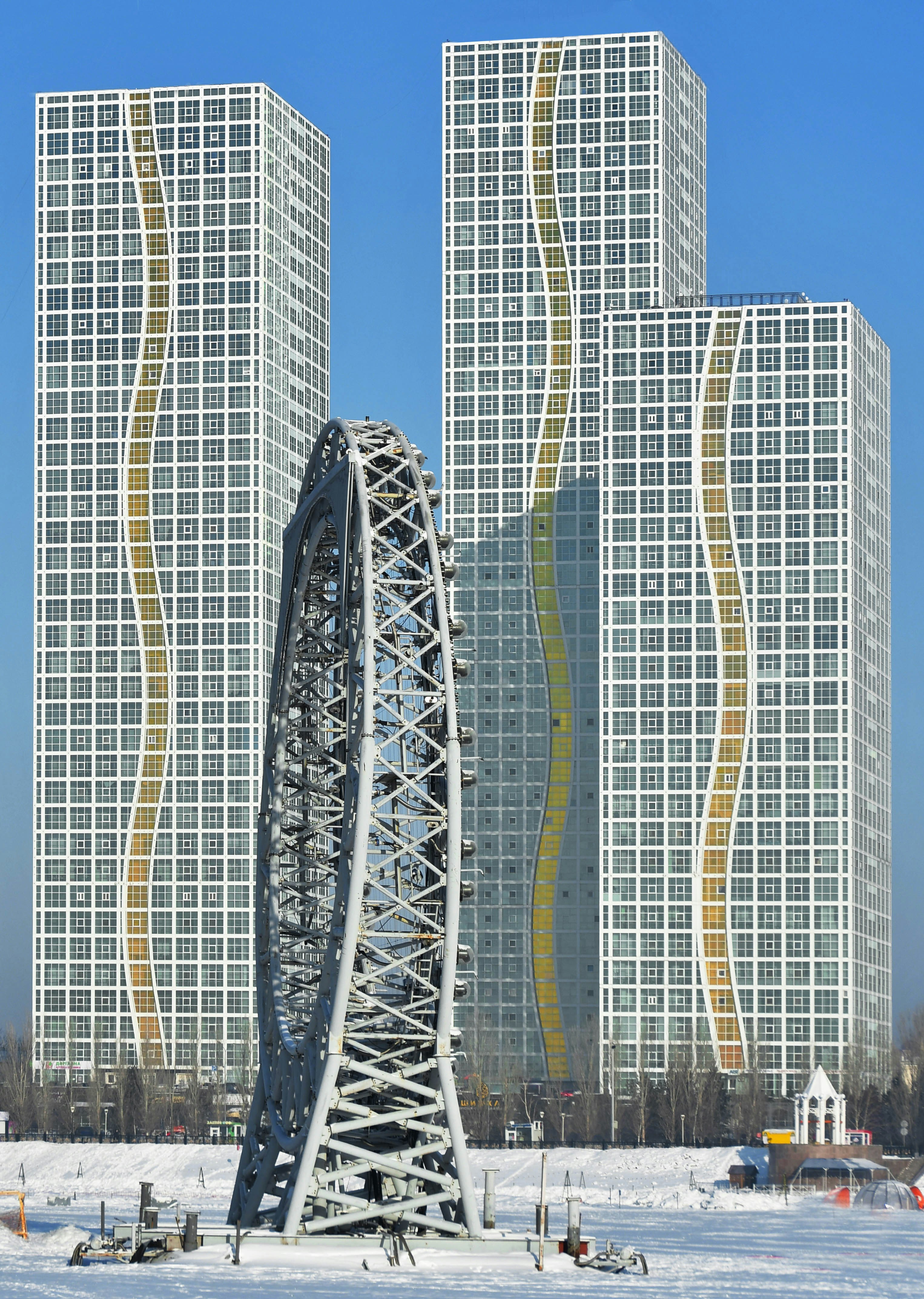 a ferris wheel in front of some tall buildings
