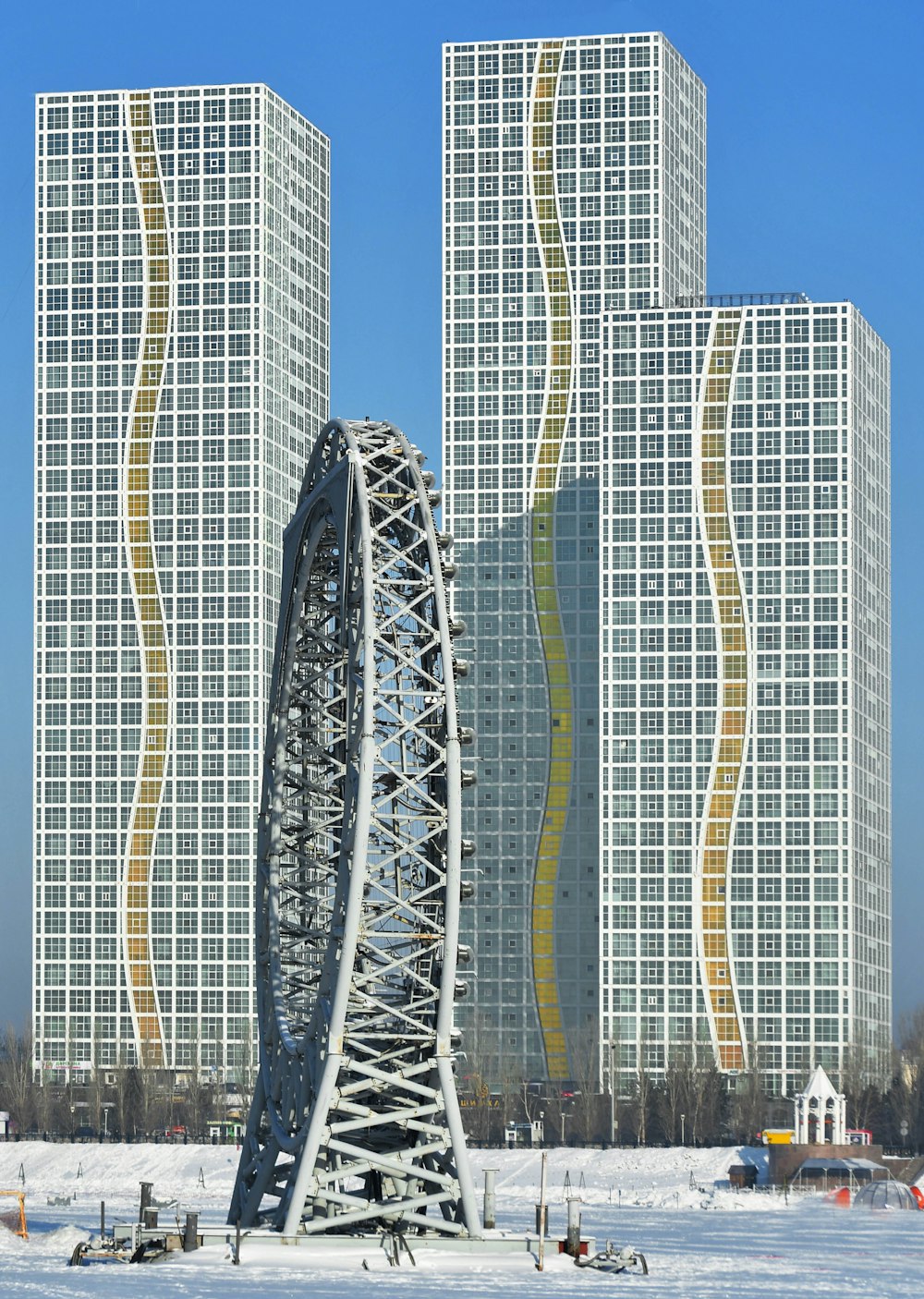 a ferris wheel in front of some tall buildings