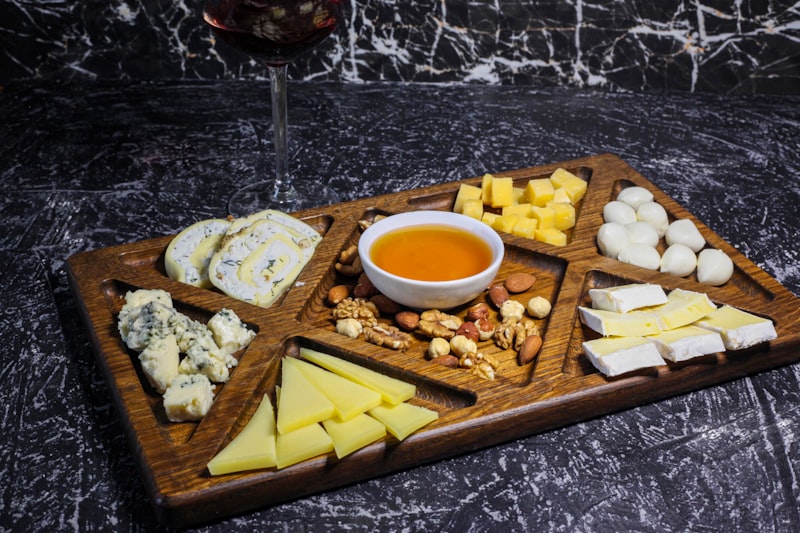 a cheese board with different types of cheese and nuts
