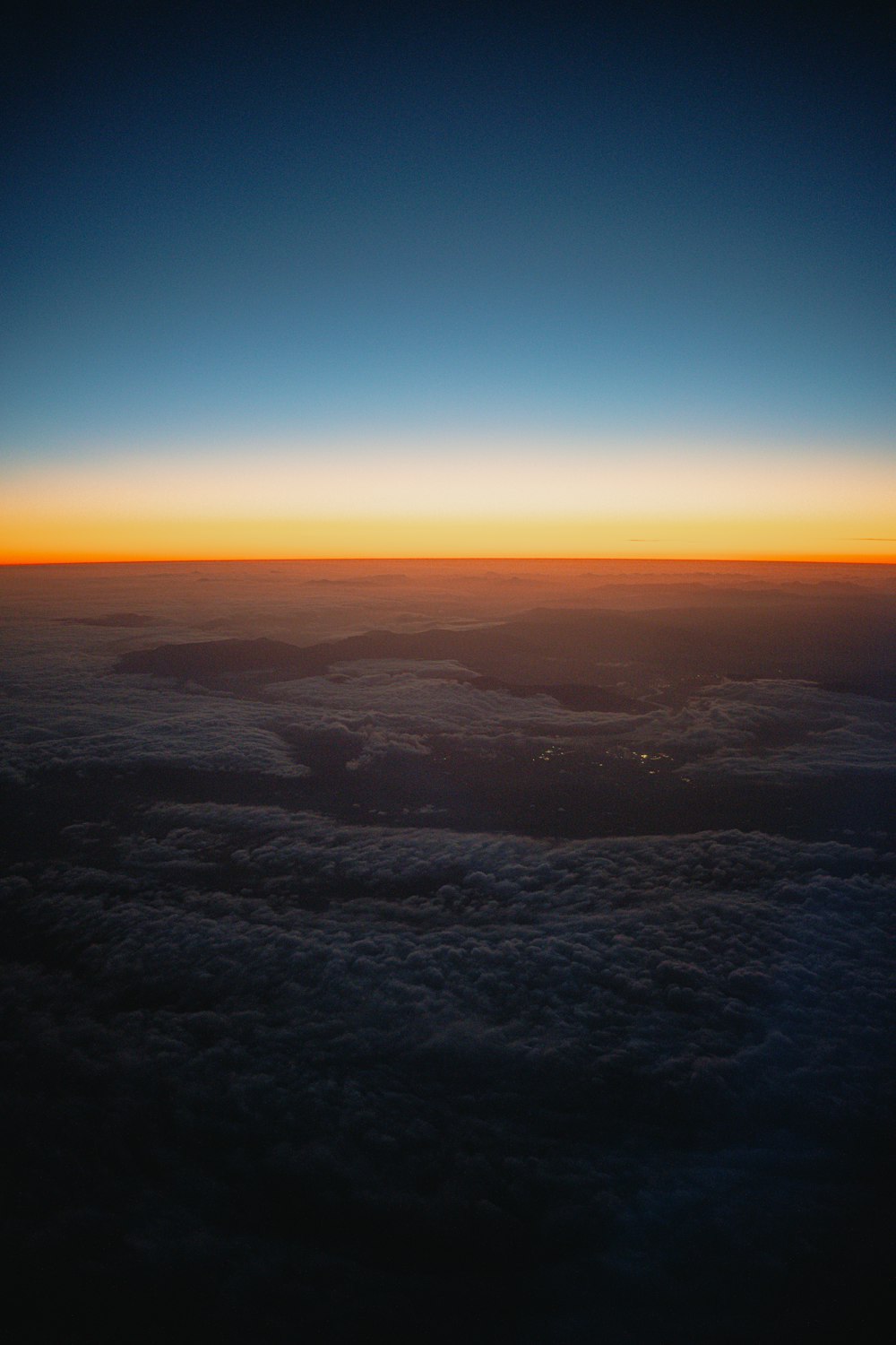 the sun is setting over the clouds in the sky