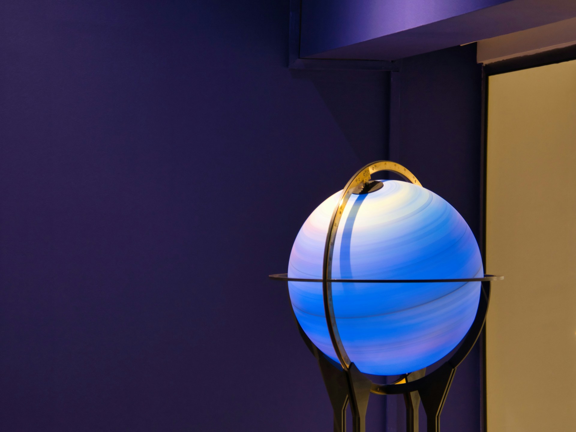 a blue and white ball on a stand in a room