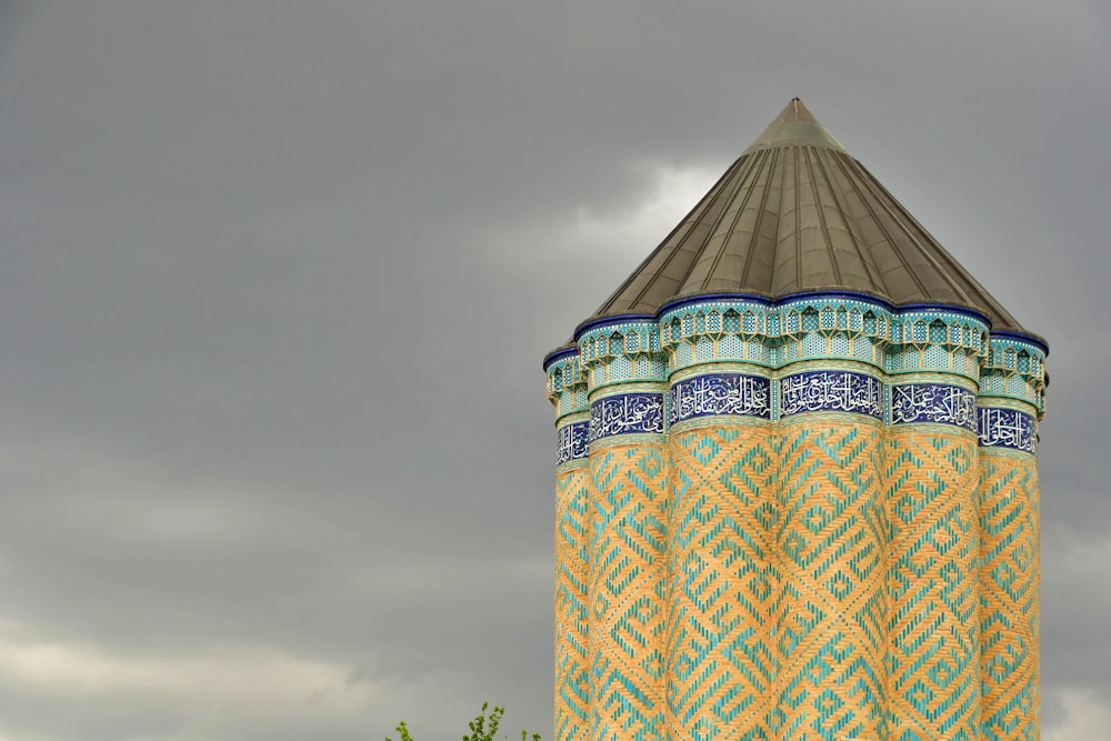 a tall tower with a blue and yellow design on it