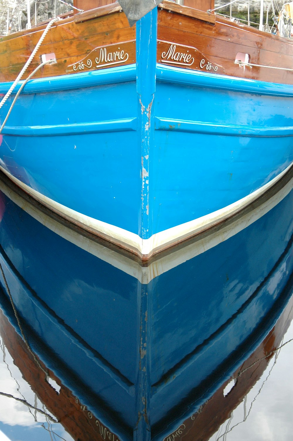 a blue boat is docked in the water