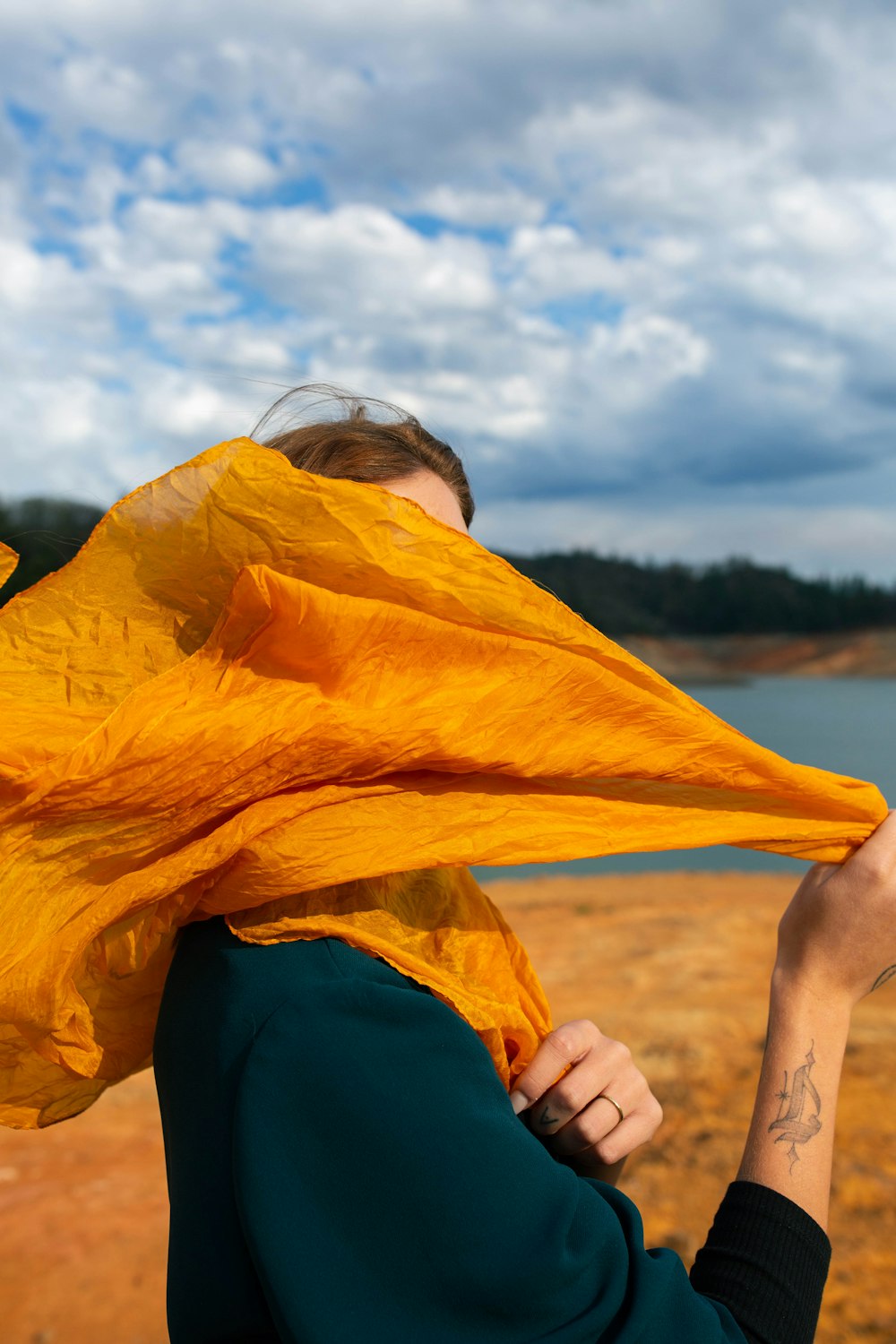 a woman with a yellow scarf around her neck