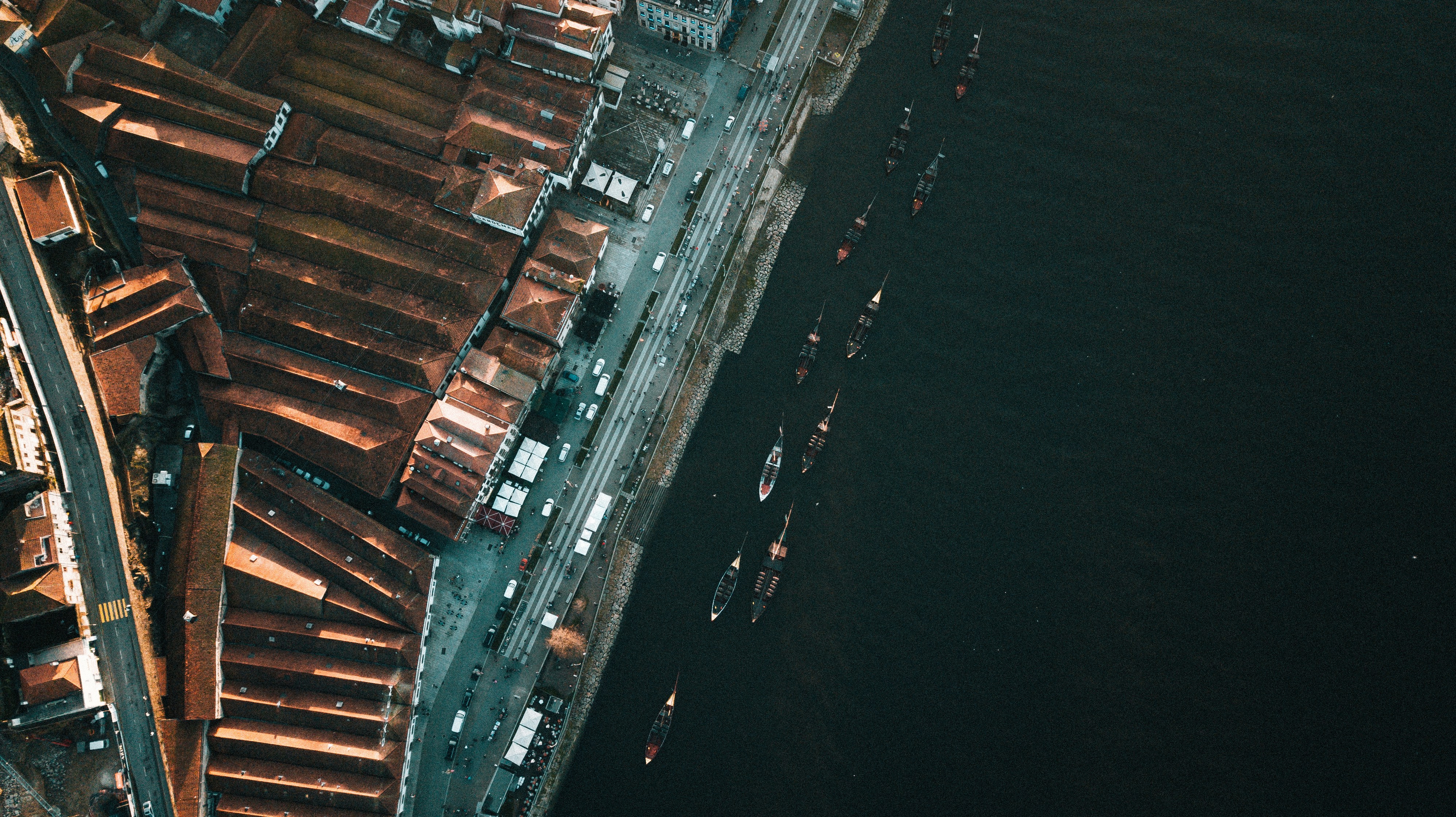 an aerial view of a city next to a body of water, 
