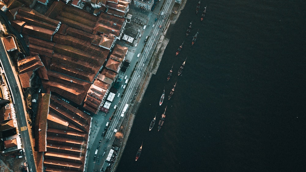 an aerial view of a city next to a body of water