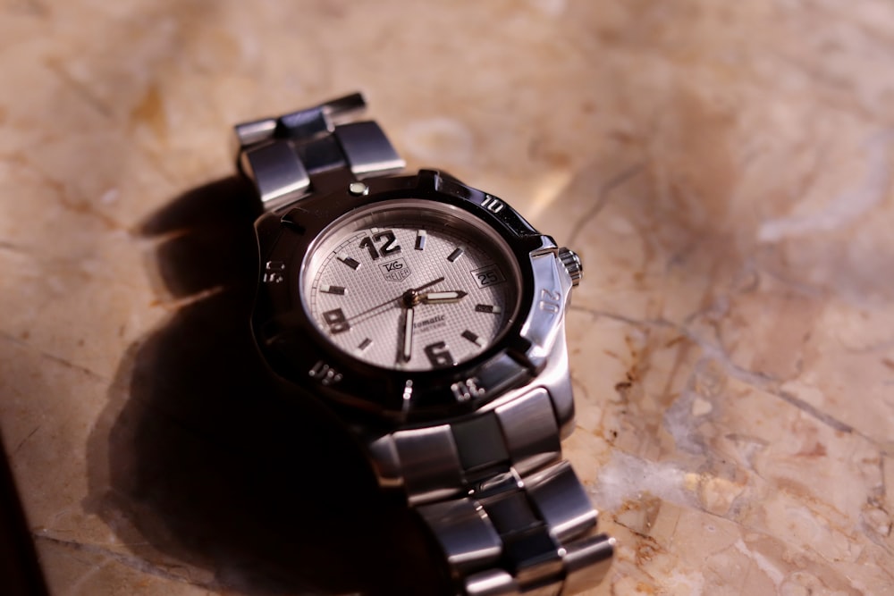 a watch sitting on top of a marble table
