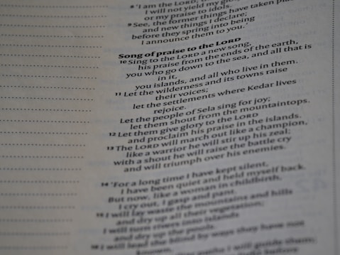 Text from a religious book printed on a page, focusing on a section titled 'Song of praise to the Lord'. It includes verses with poetic language praising divine qualities and actions.