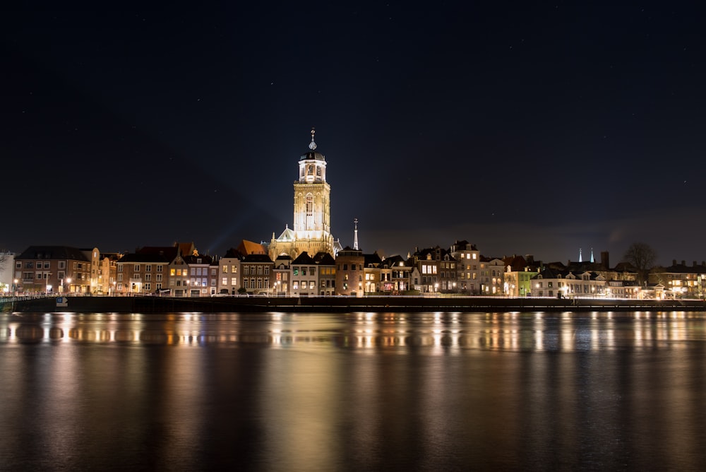 a night view of a city with a clock tower