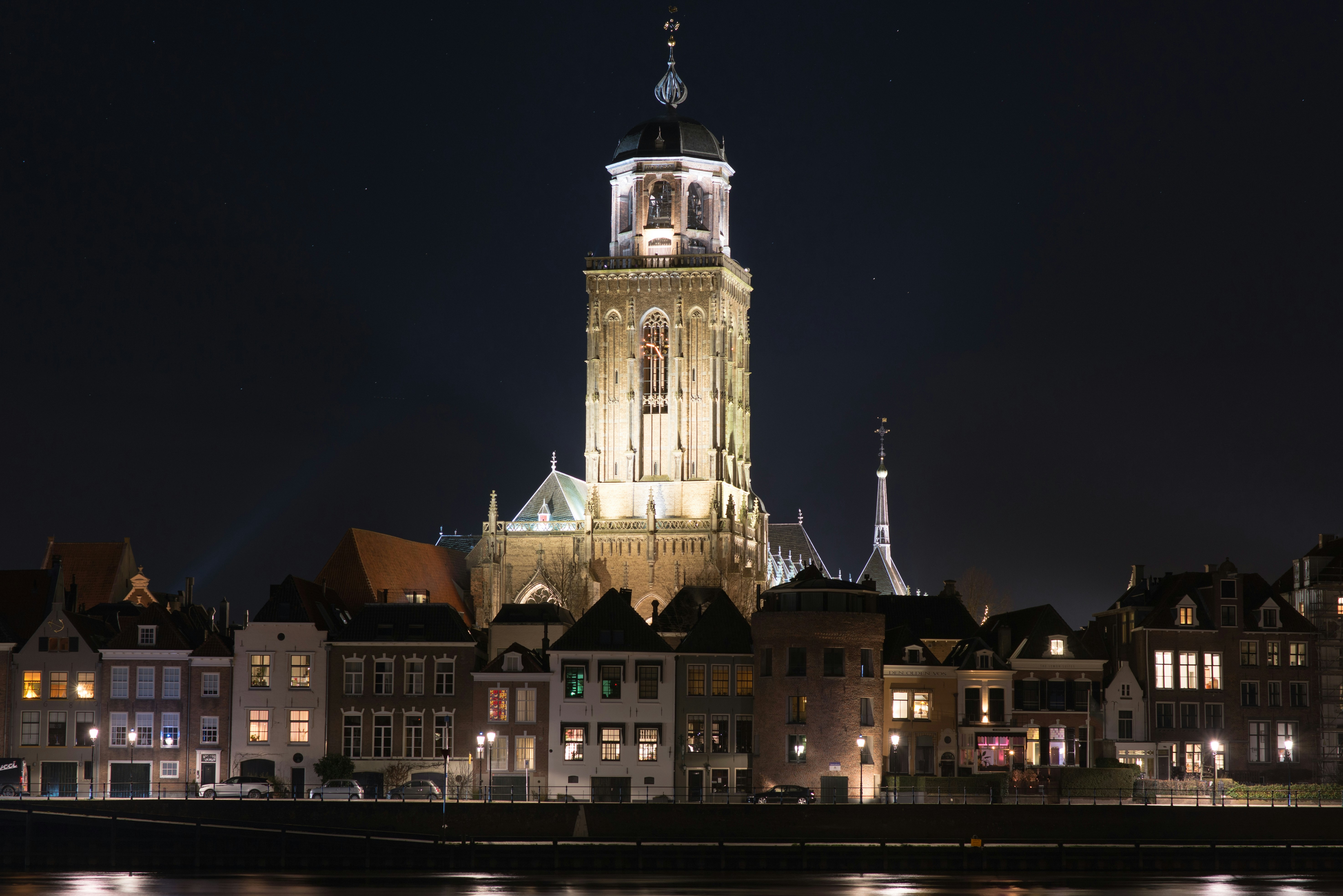a large clock tower towering over a city at night
