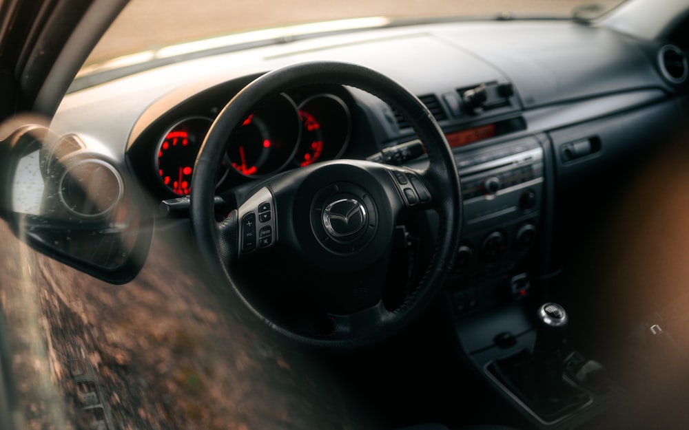 the dashboard of a car with a red light on