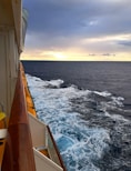 A ship captain reviewing paperwork on the deck with the ocean in the background.