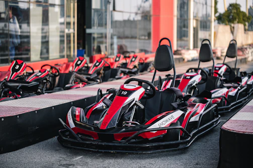Wide shot of the starting grid with karts revving engines, ready to launch.