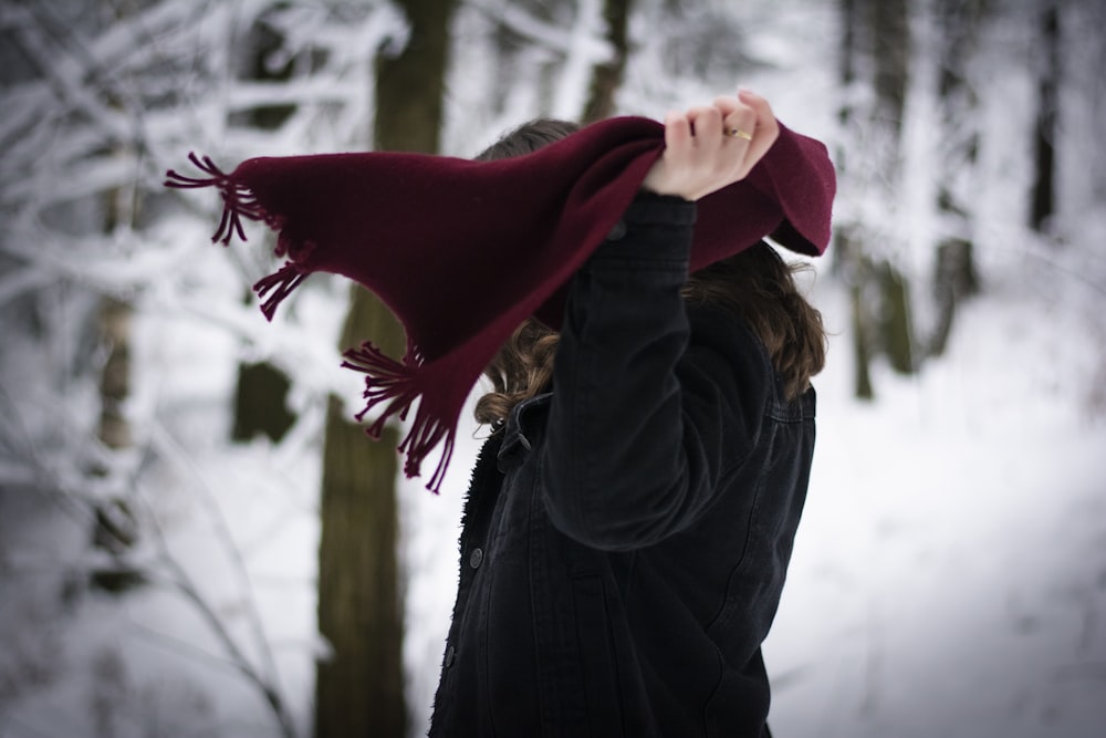 Una donna che indossa un cappello marrone e una sciarpa