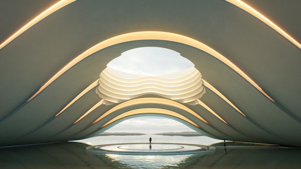 a futuristic building with a man standing in the middle of it