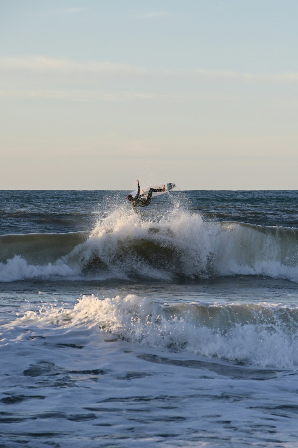 a person riding a wave on top of a surfboard