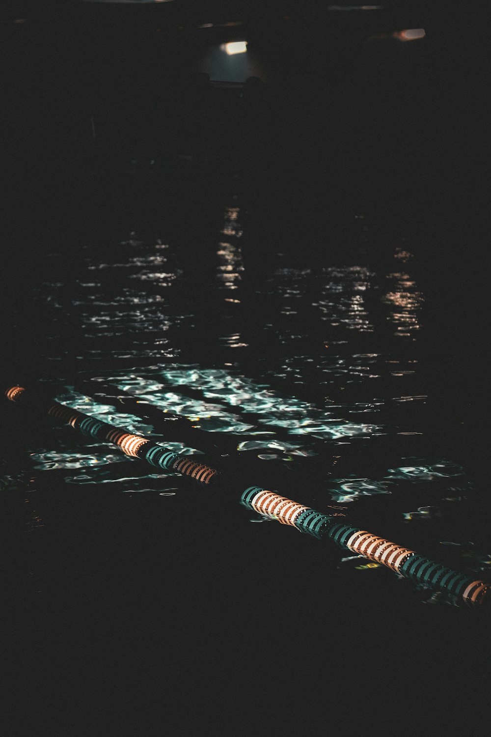 a row of boats floating on top of a body of water