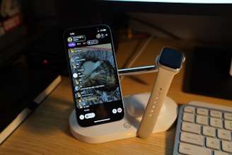 a cell phone sitting on top of a desk next to a keyboard