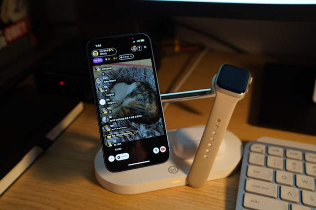 a cell phone sitting on top of a desk next to a keyboard