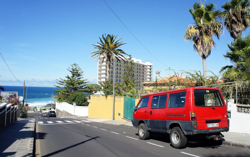 a red van is parked on the side of the road