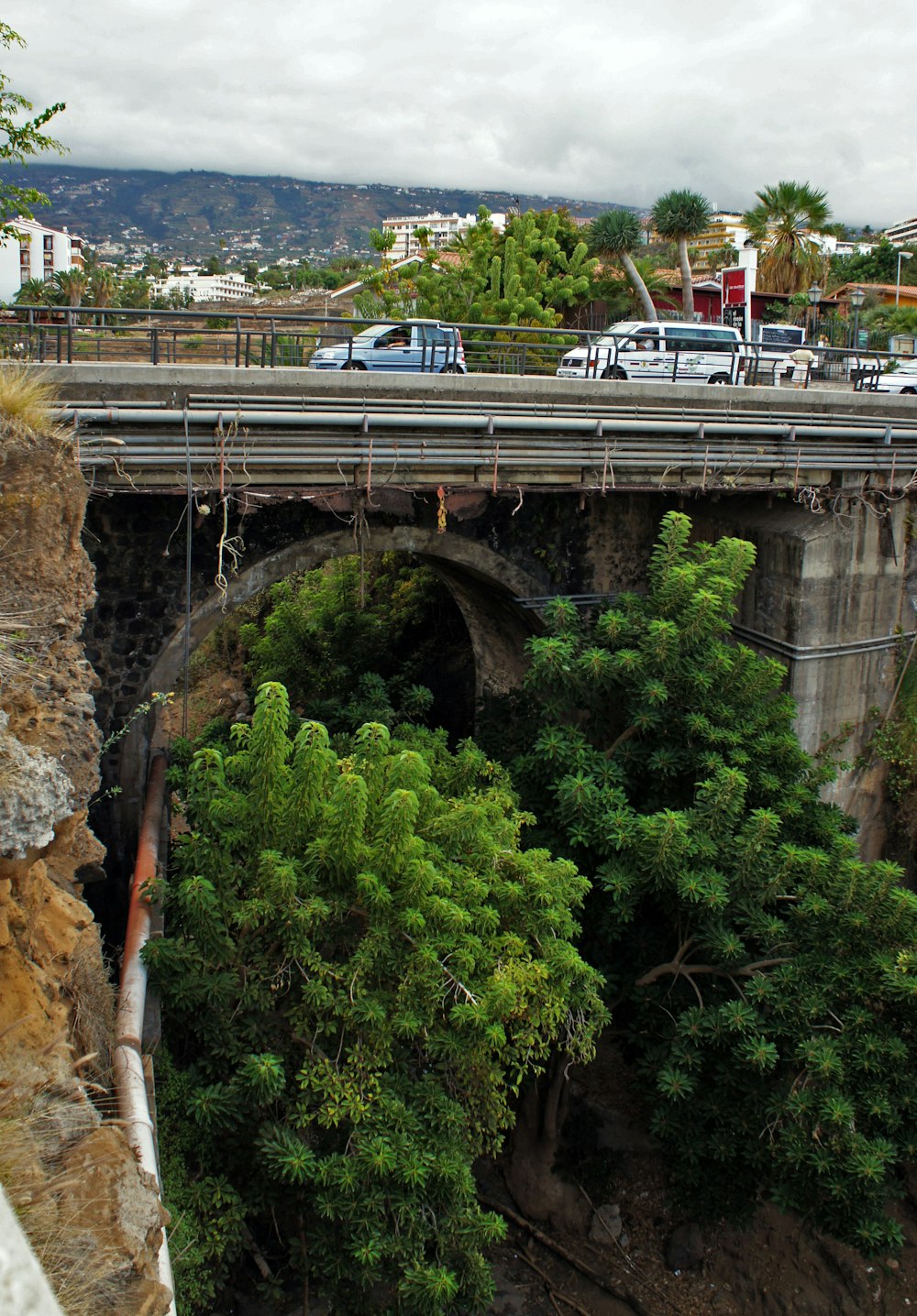 a bridge over a river with cars driving on it