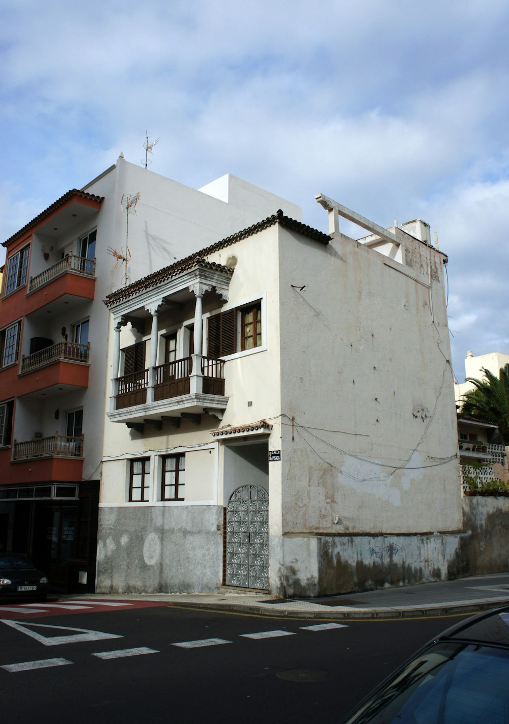 a large white building sitting on the side of a road