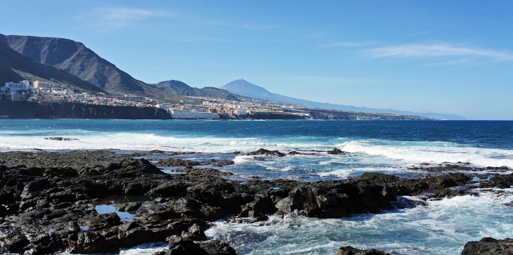 a view of the ocean with a city in the distance