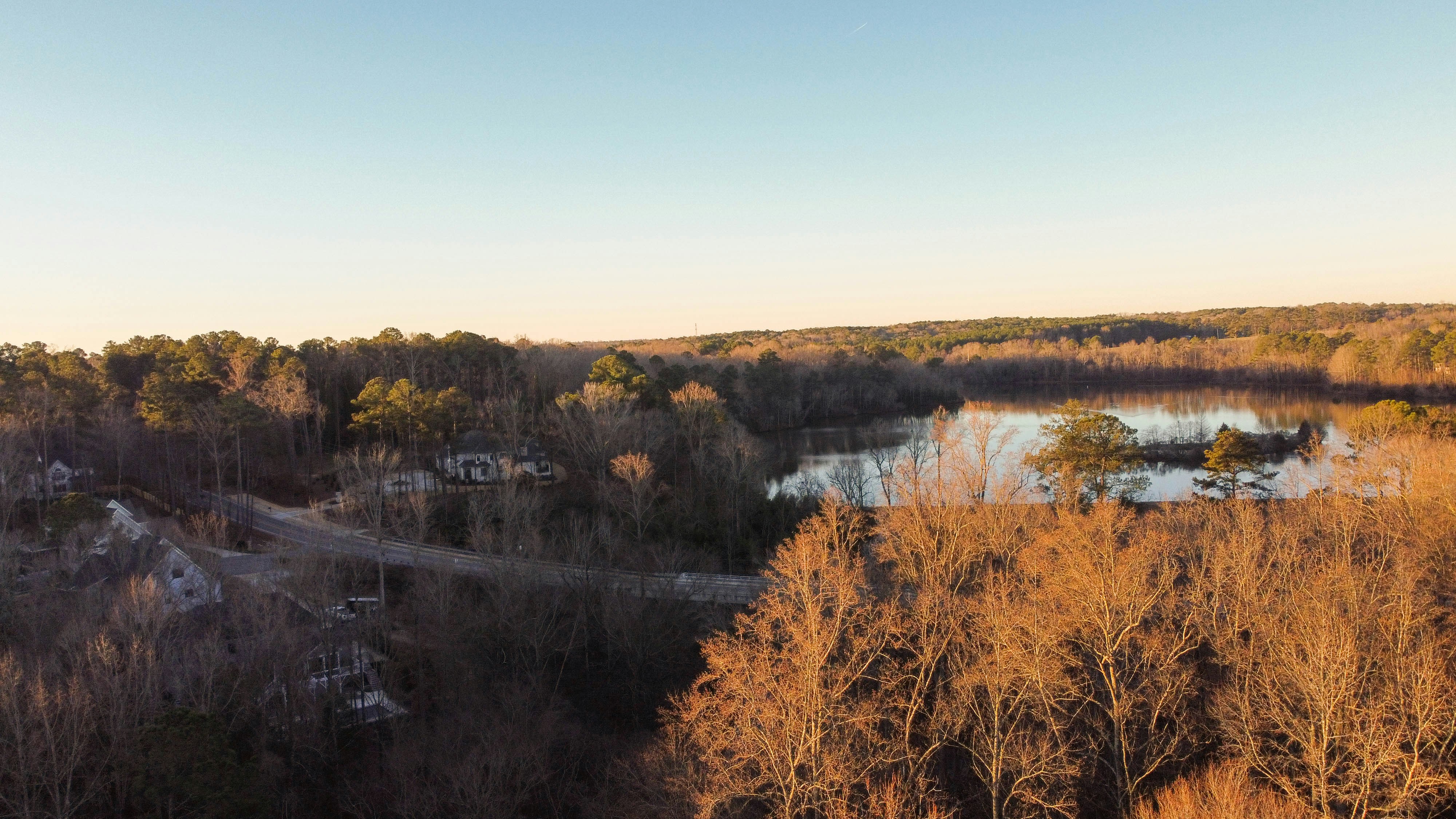 an aerial view of a river surrounded by trees