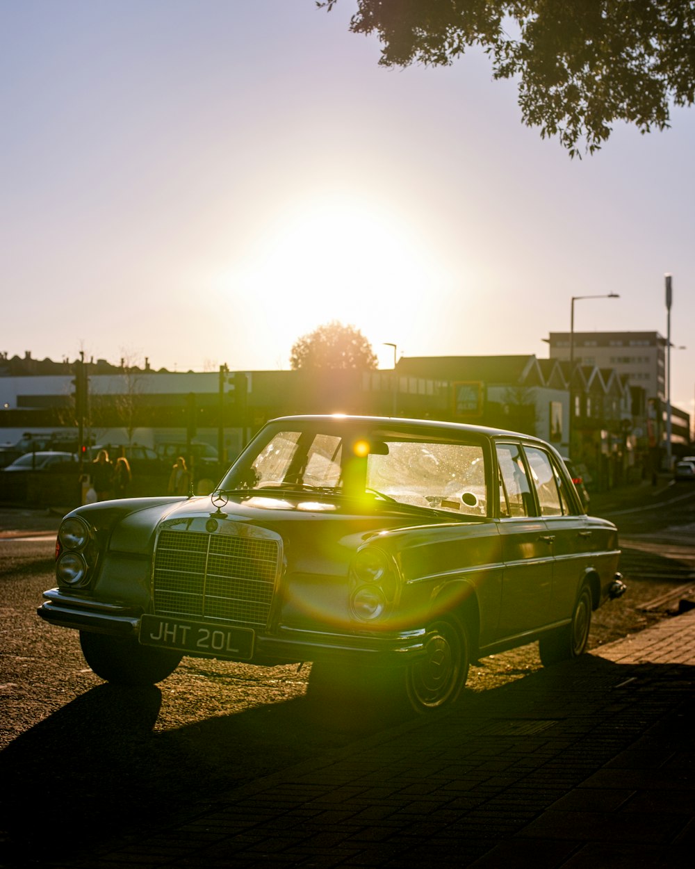 a green car parked on the side of a road