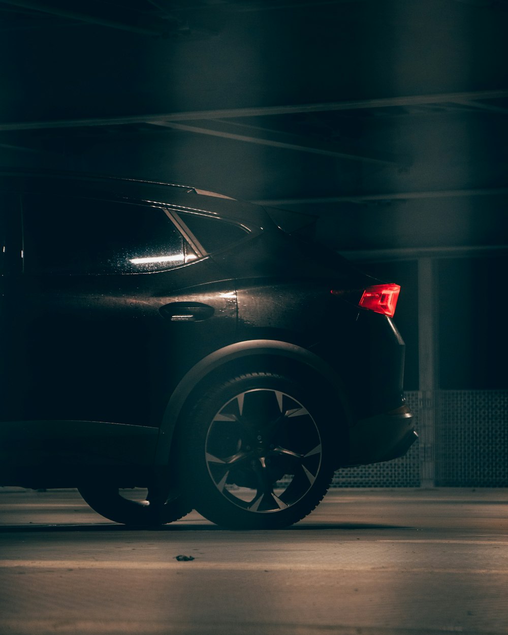 a car parked in a parking garage at night