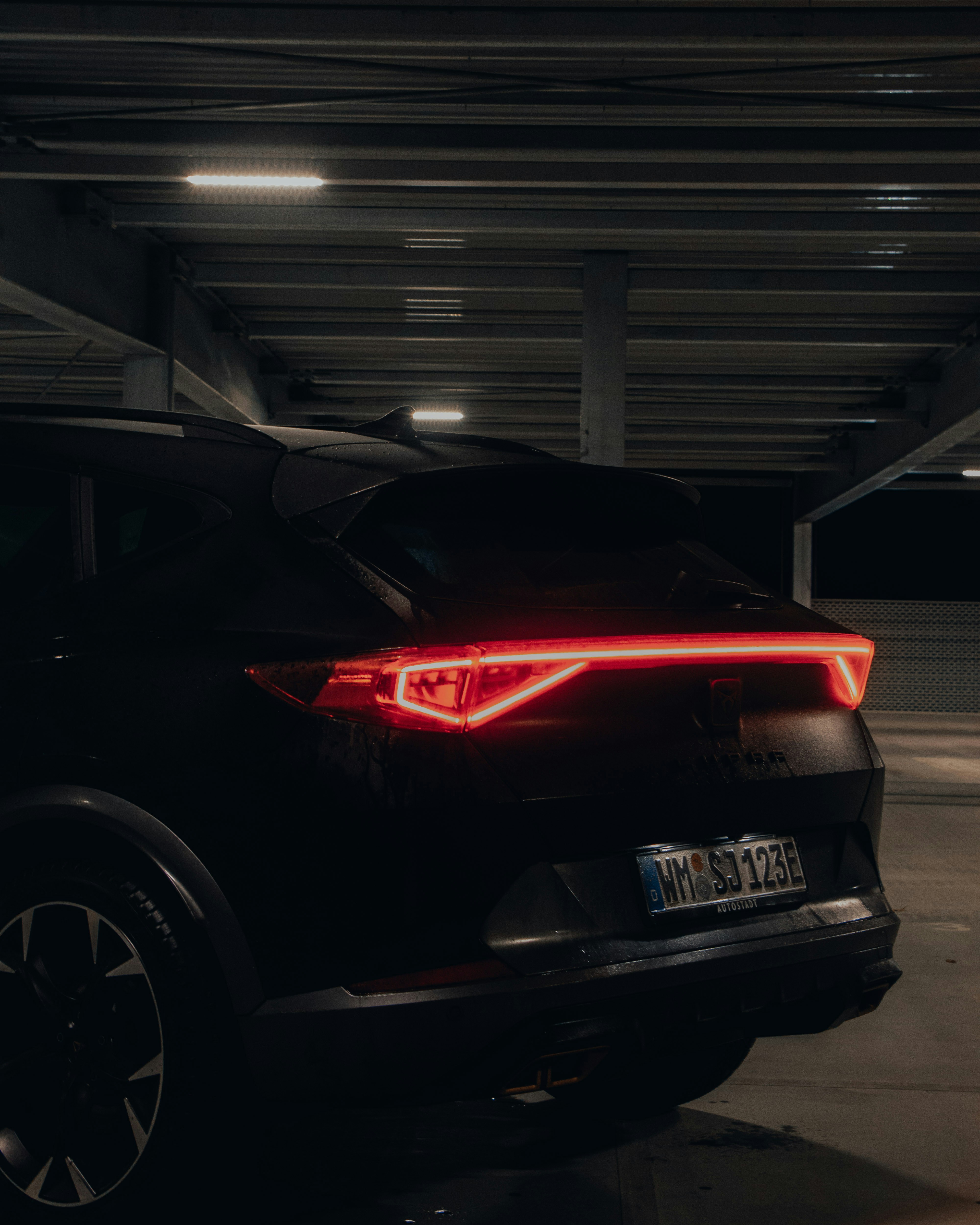 a black car parked in a parking garage