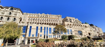 Elegant navy blue accented building with landscaped front yard