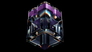 A 3D geometric sculpture with a glossy, reflective surface is centered against a black background. The structure features complex shapes with sharp edges and consists of transparent and purple-tinted sections.