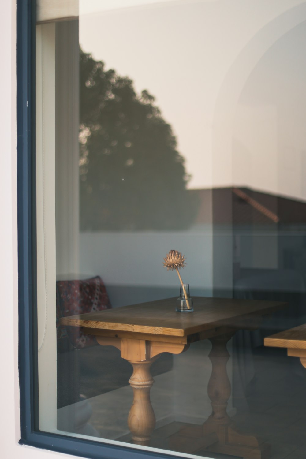 a wooden table sitting in front of a window