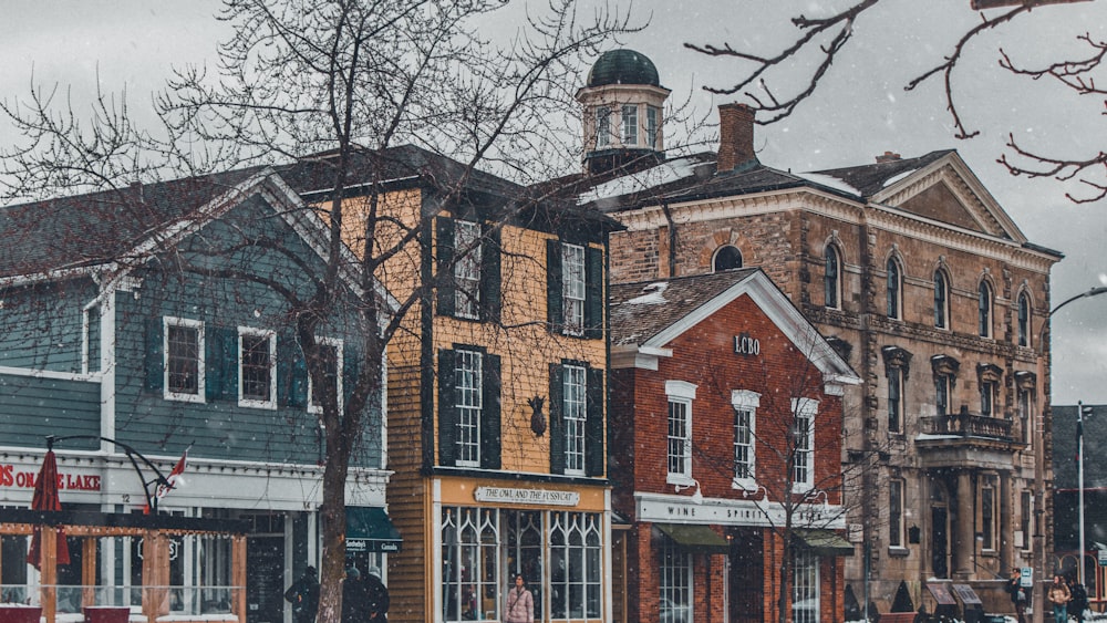 a row of buildings on a snowy day