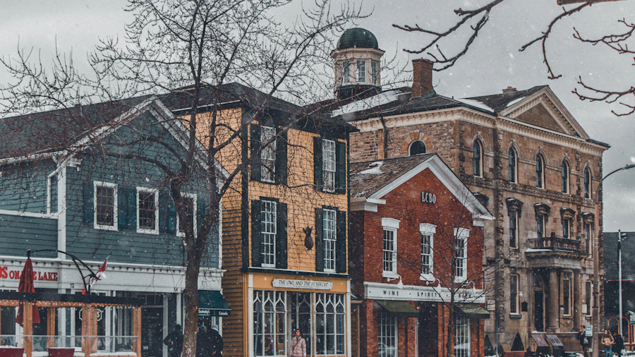 Niagara-on-the-Lake historic main street in winter with snow falling, Georgian and Victorian brick buildings lining the street