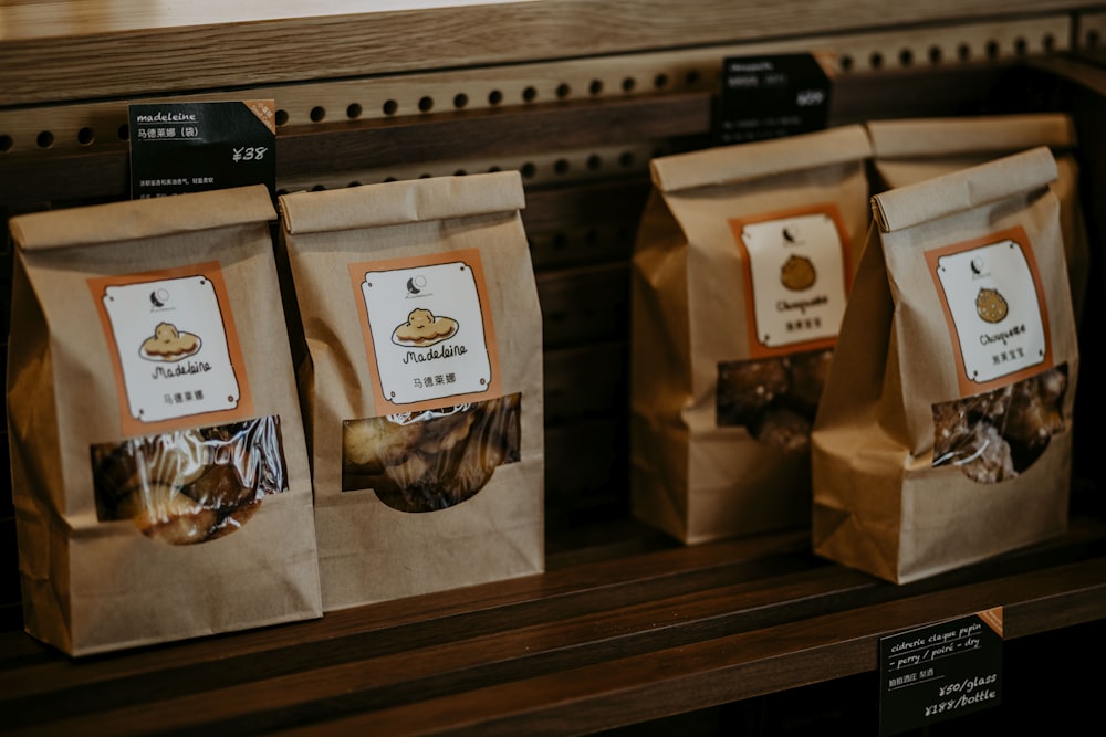 three bags of food sitting on top of a shelf