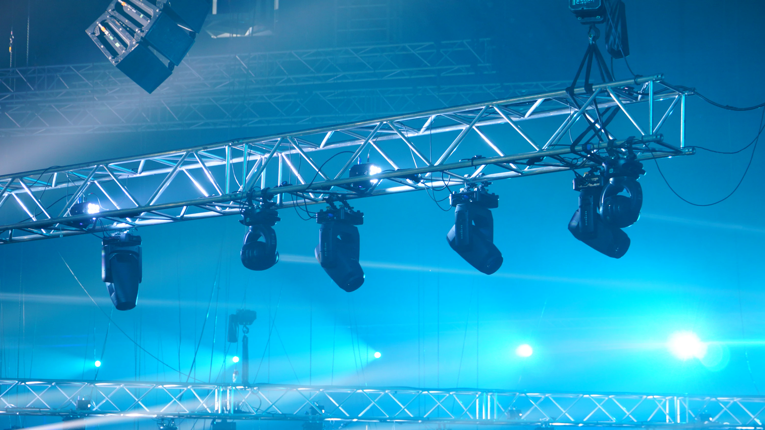 Stage lighting rig casting blue light