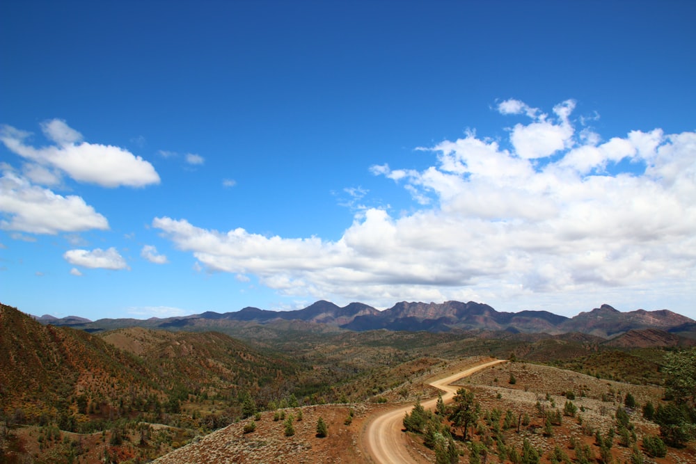 a dirt road in the middle of a mountain range